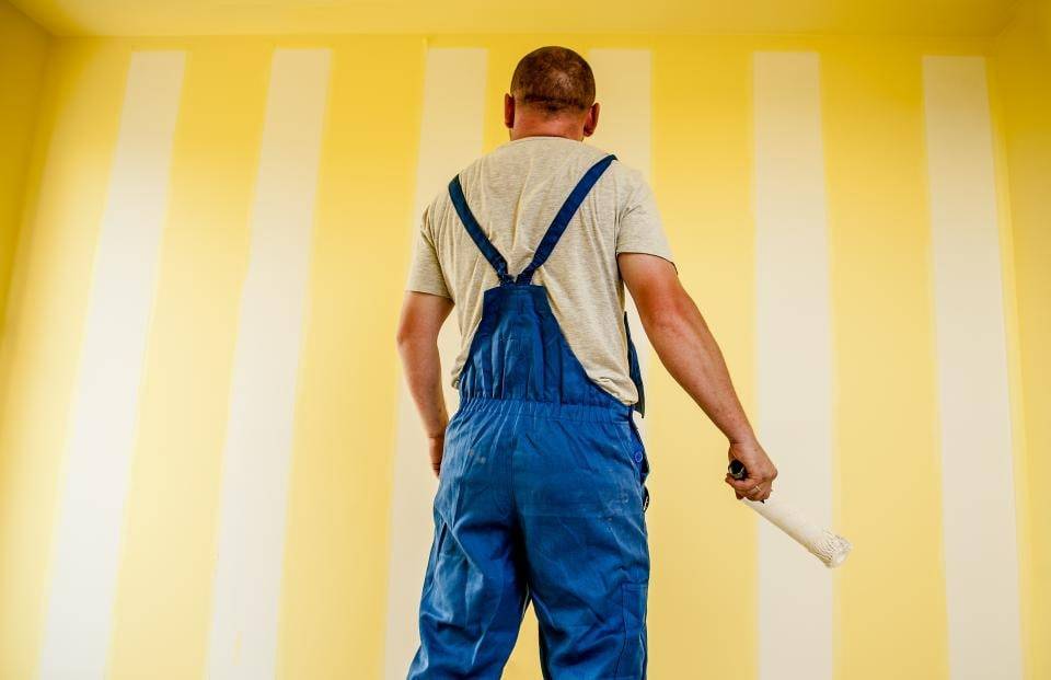 Painter rolling a fresh coat onto a wall