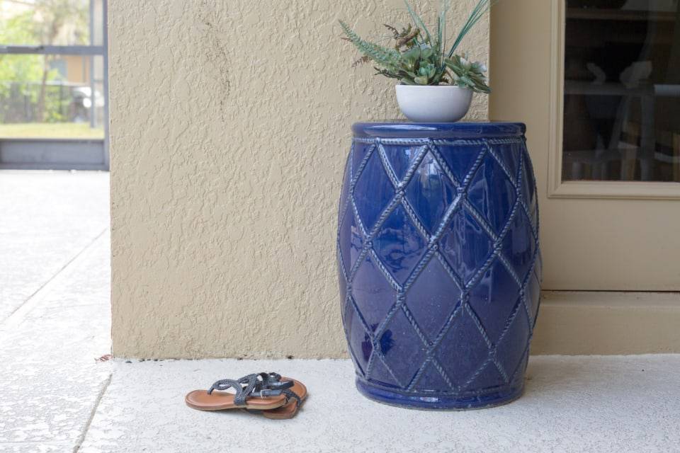Stucco porch with a blue ceramic planter